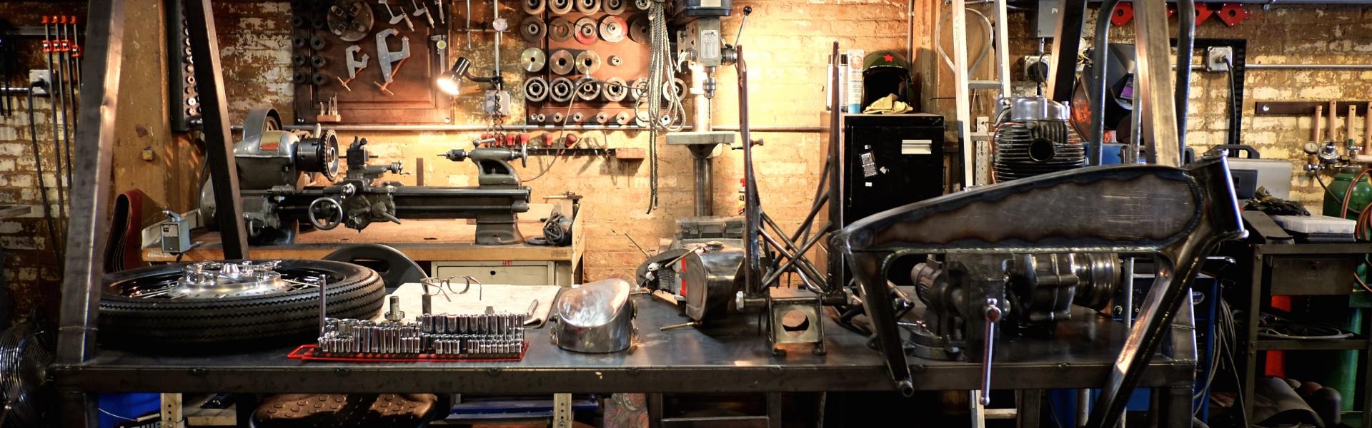 motorcycle parts strewn around a garage